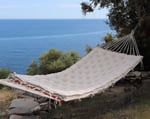 tufted wool cushion on hammock by the sea