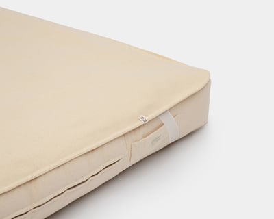 wool mattress protector showing how it attaches to the wool mattress