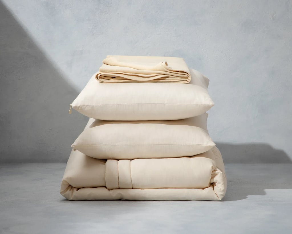 home of wool duvet, protector and pillow bundle on grey background