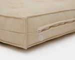 close up of wool crib mattress with mini piping design of the edges and metal zipper