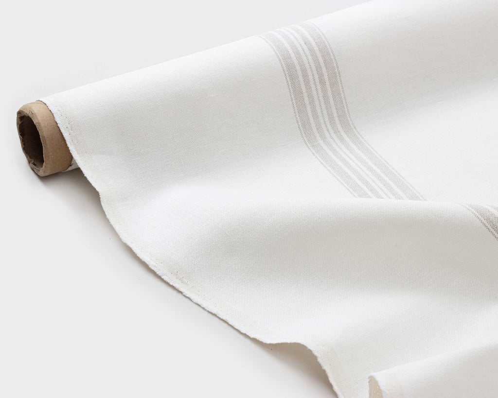 grey striped linen fabric on the floor with folds