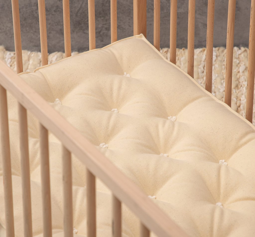wool baby mattress in wooden crib