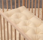 wool baby mattress in wooden crib