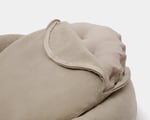 close up of open cover of round pet bed with wool cushion inside