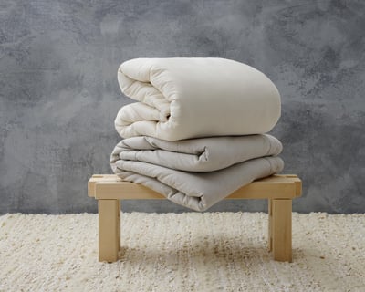 Wool duvet insert folded over and on a bench from different fabrics