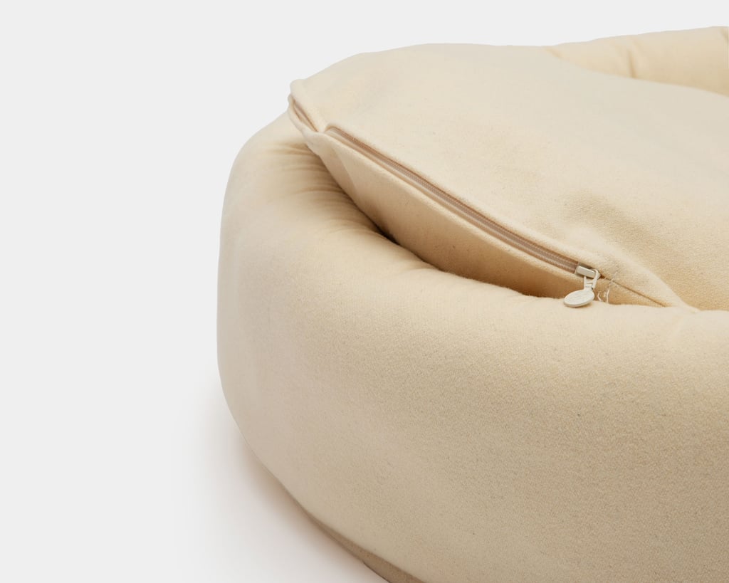 close up of round wool dog bed showing the zipper