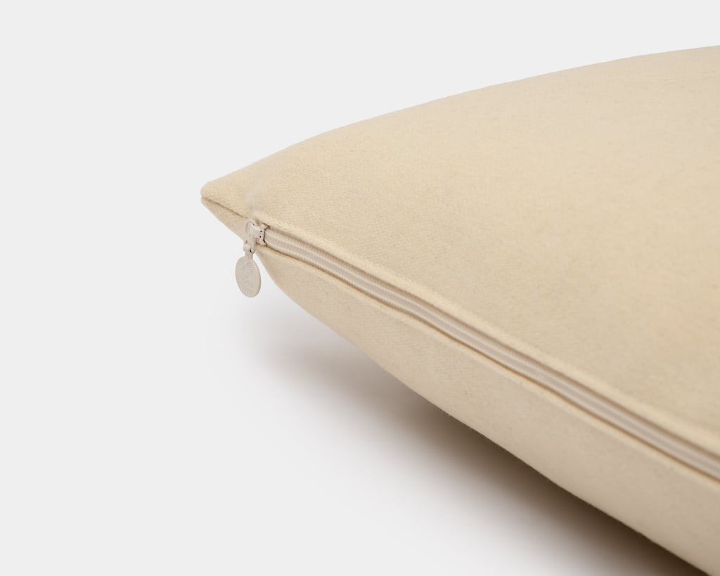 detail of wool pillow with home of wool zipper