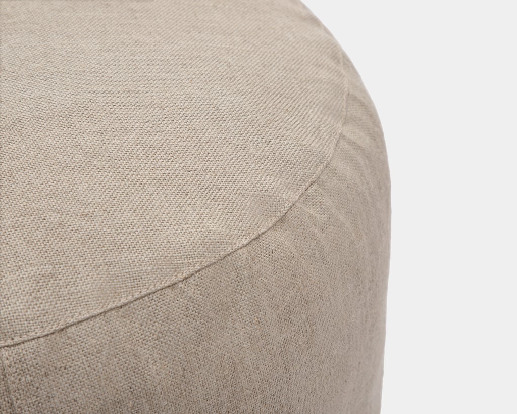 detail of round pouf in textured linen fabric