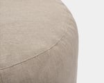 detail of round pouf in textured linen fabric