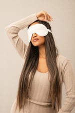 girl with sleeping mask on her eyes