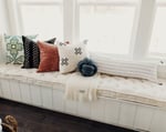 wool tufted seat cushion on a window sill