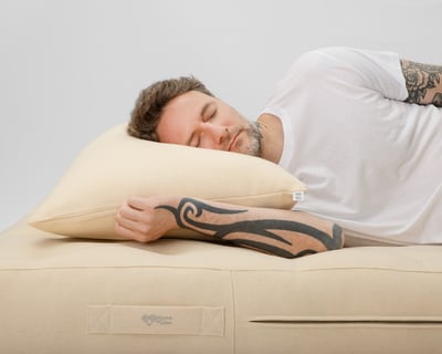 wool pillow with a man sleeping on it
