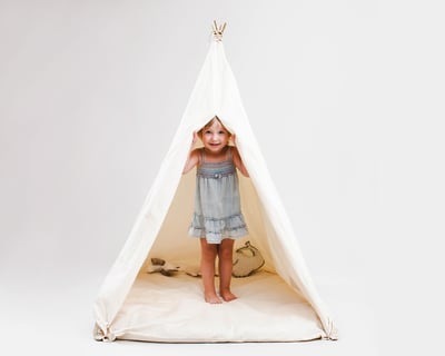 kids teepee tent in full view, wit the curtains open and a child inside