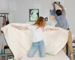 Basta wool duvet held by a happy girl dancing on a bed