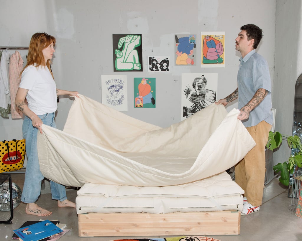 Basta wool duvet held by people on a bed