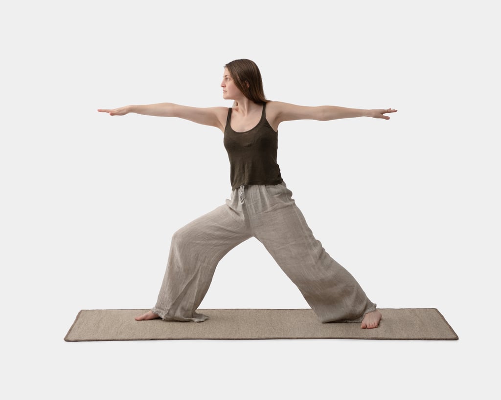 A girl is practicing yoga on a wool yoga mat