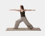 A girl is practicing yoga on a wool yoga mat