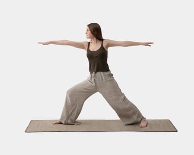 A girl is practicing yoga on a wool yoga mat