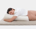 young woman laying on wool yoga bolster