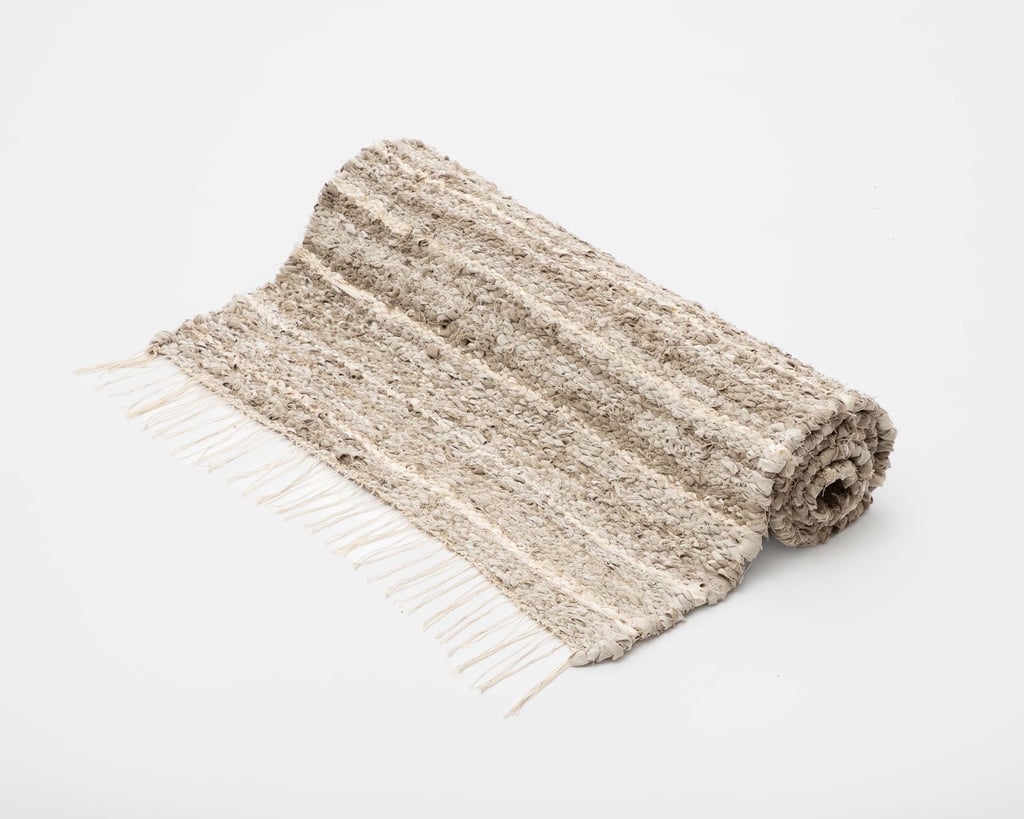 rolled up handwoven linen area rug