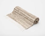 rolled up handwoven linen area rug