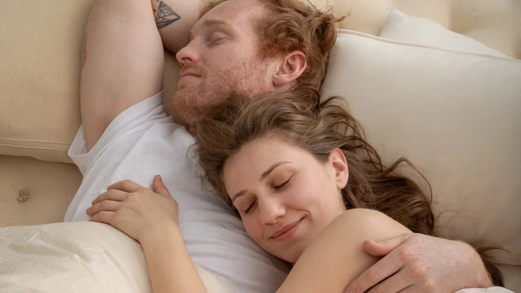 man and woman laying on a home of wool mattress