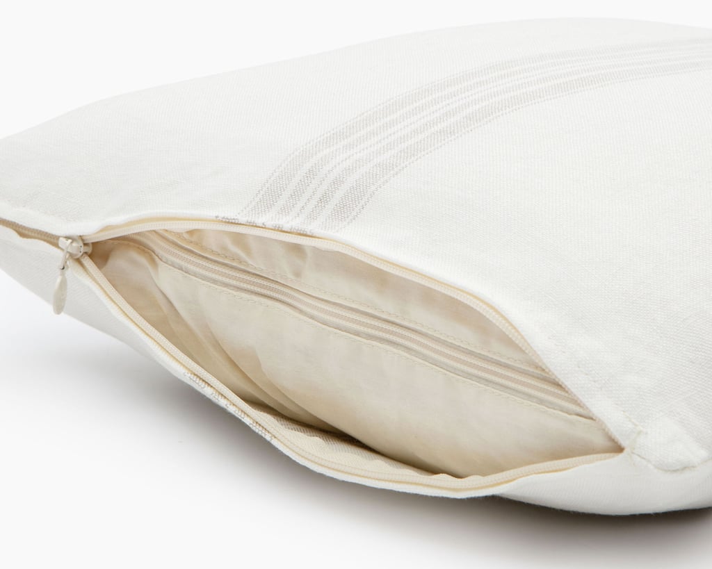 Wool throw pillow with linen pillowcase close up, unzipped cover