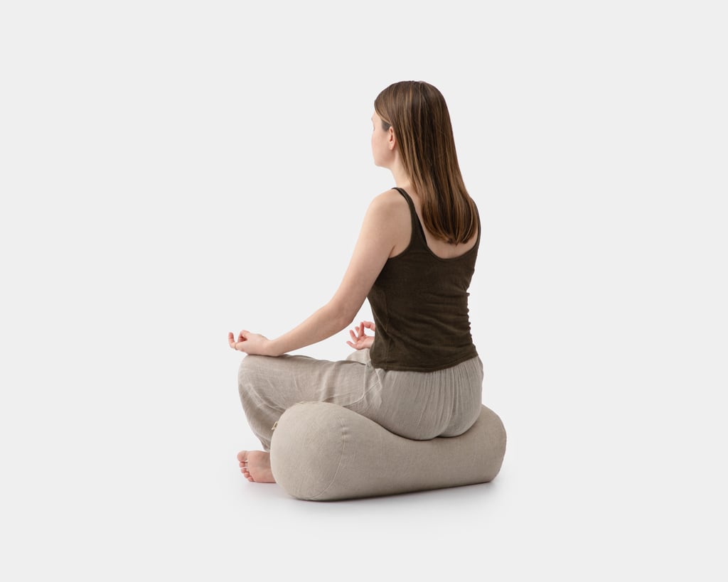 wool yoga bolster with a girl sitting on it