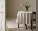 home of wool tablecloth on a table, decorated with a flower vase and a chair