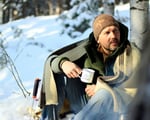 man drinking hot drink outdoors wrapped winter nomad heat heavy wool blanket