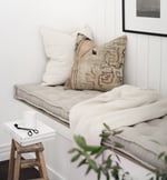 wool tufted seat cushion on a window sill