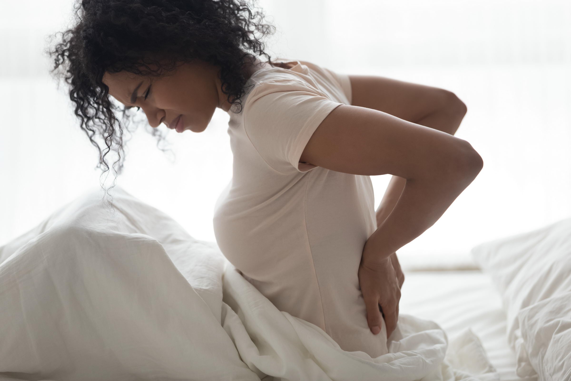 woman with backpain Sad,Young,African,Woman,Touching,Back,Feeling,Backache,Morning,Discomfort