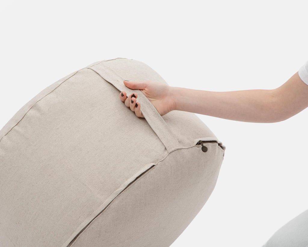 hand holding a home of wool pouf