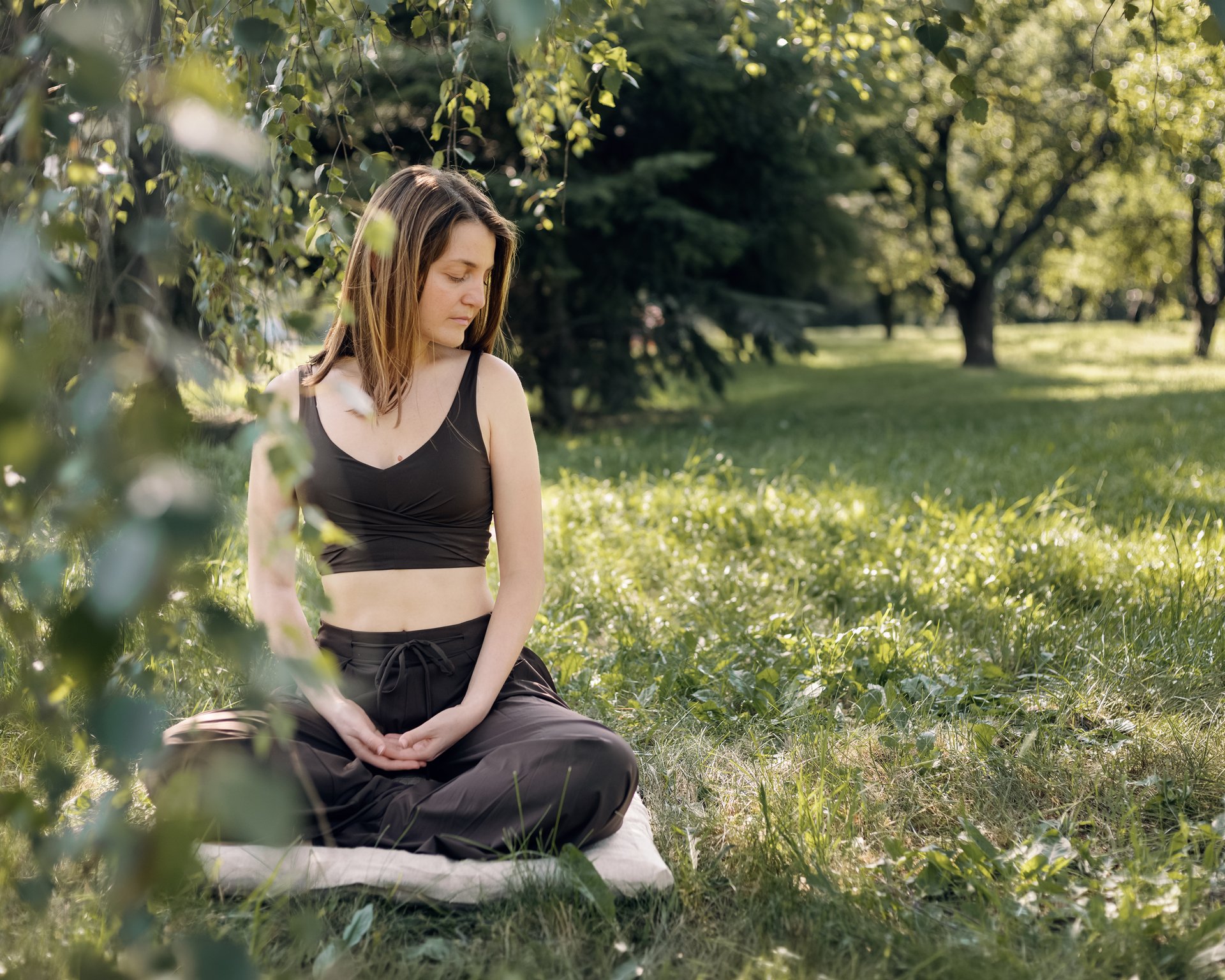 Girl meditate in the park on wool zabuton pillow