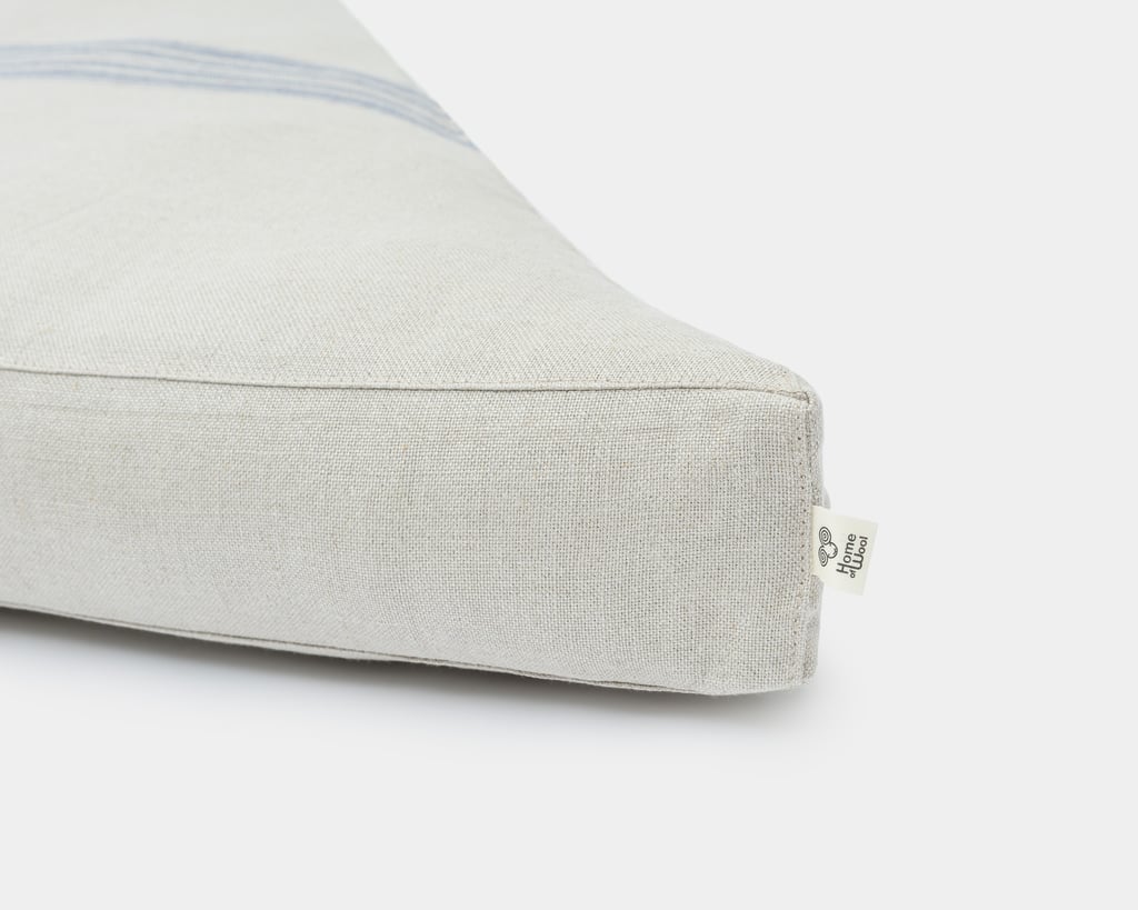 wool trapezoid tufted seat cushion with removable linen cover detail