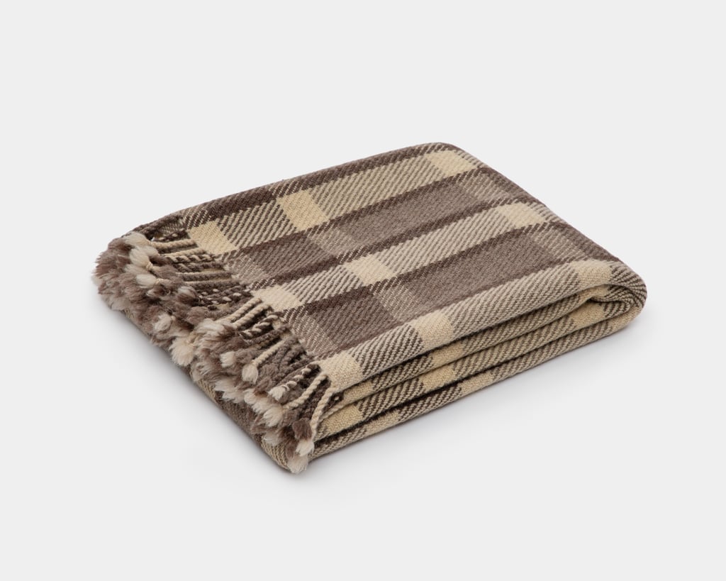 checkered wool blanket folded on white background