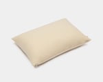 wool pillow protector on a pillow on a white background