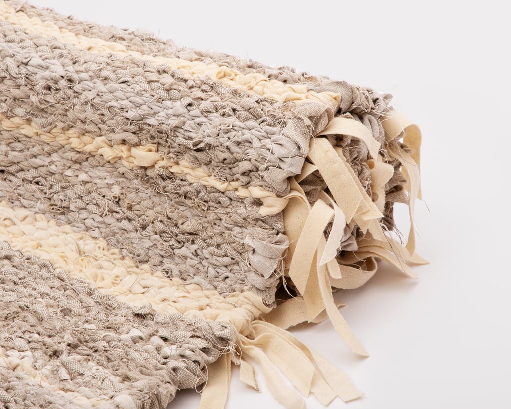 close up of zero waste linen and cotton rug with wool fringes