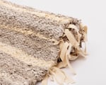 close up of zero waste linen and cotton rug with wool fringes