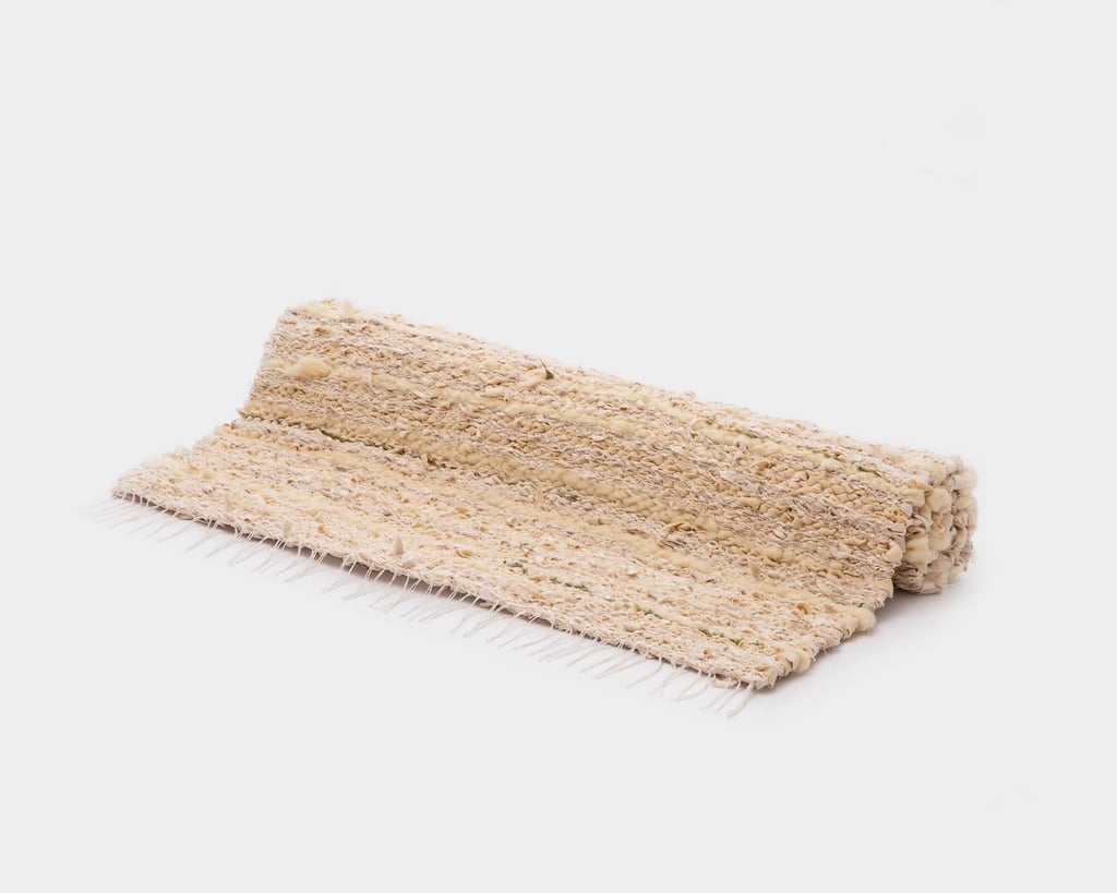 rolled up rustic handwoven wool rug