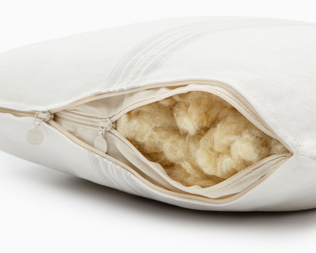 Wool throw pillow with linen pillowcase unzipped showing wool filling