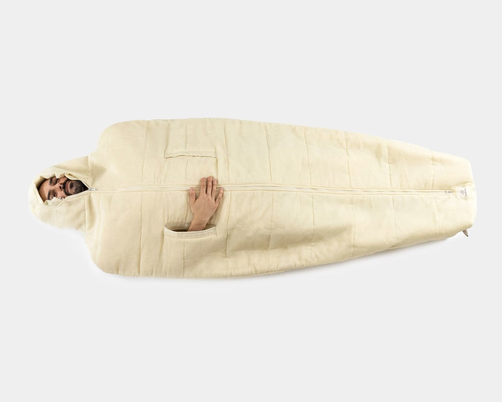 trek pro sleeping bag with a person inside showing hand through access holes