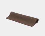 flat woven rug rolled up in natural brown color