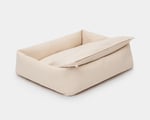 wool dog bed with a cushion