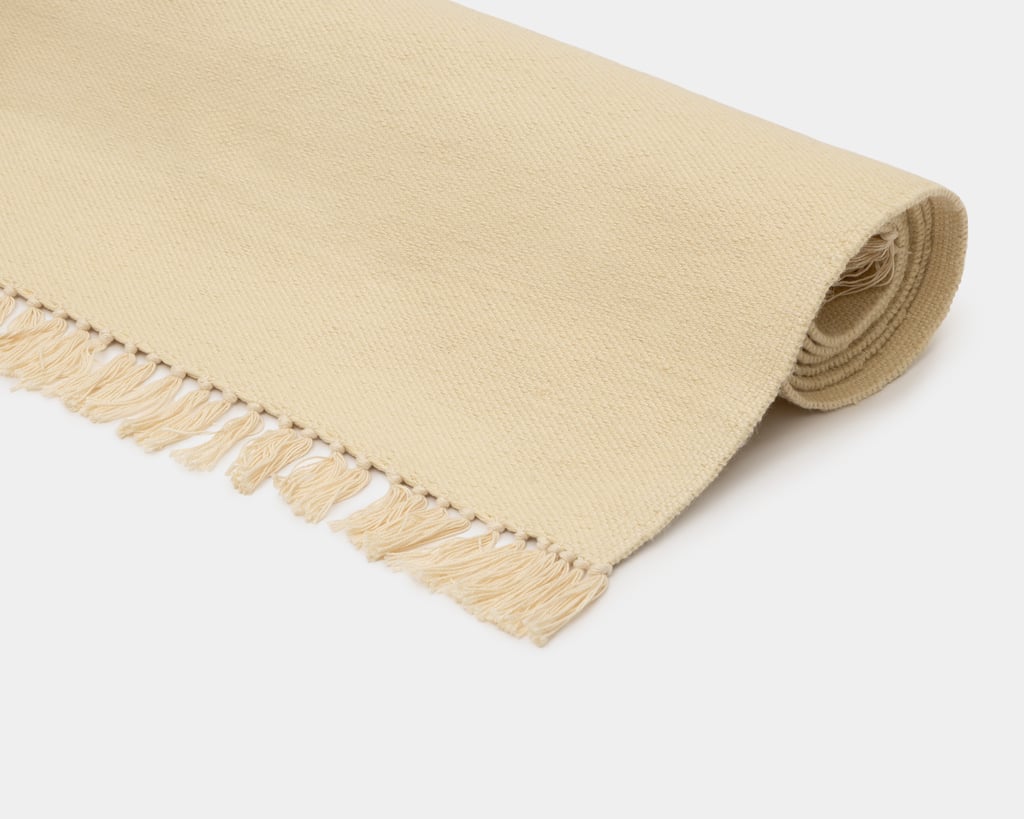 flat woven wool rug in natural white color close up