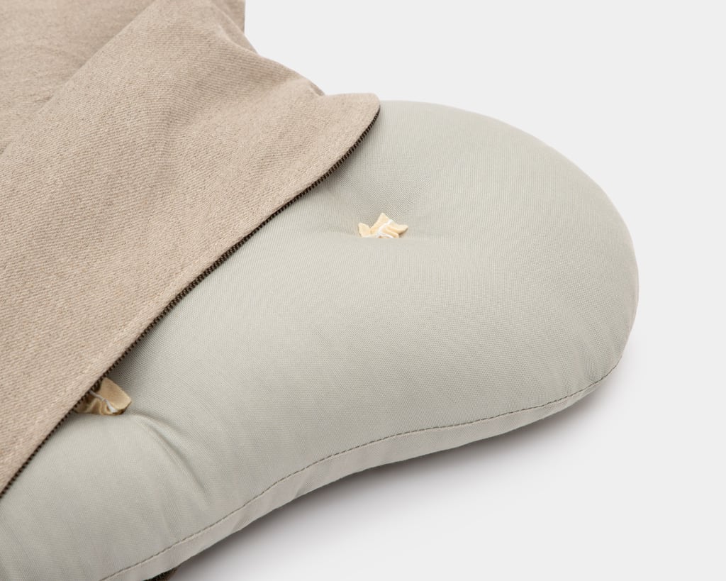 wool dog bed shaped like a bone close up unzipped fabric