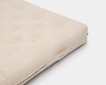 Wool mattress with cotton fabric on white background.