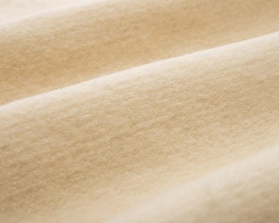 close up of karakul wool fabric texture by home of wool