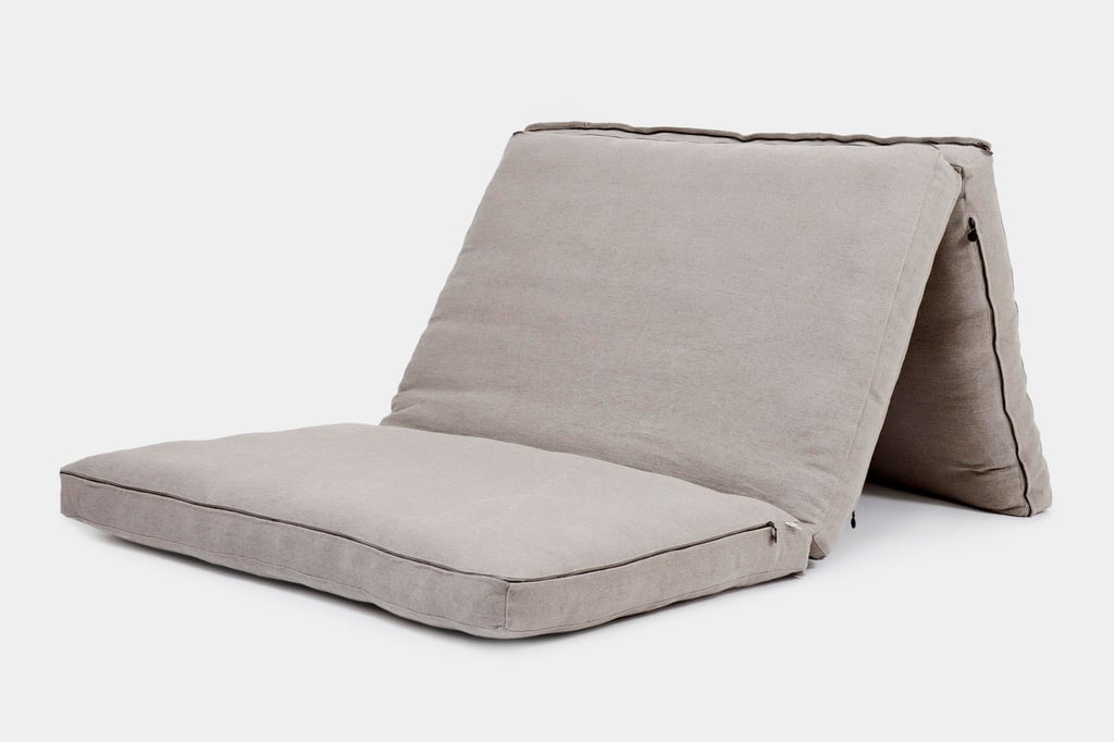 Gray folding mattress with three connected sections, shown partially folded.