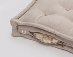 wool tufted seat cushion in linen showing filling